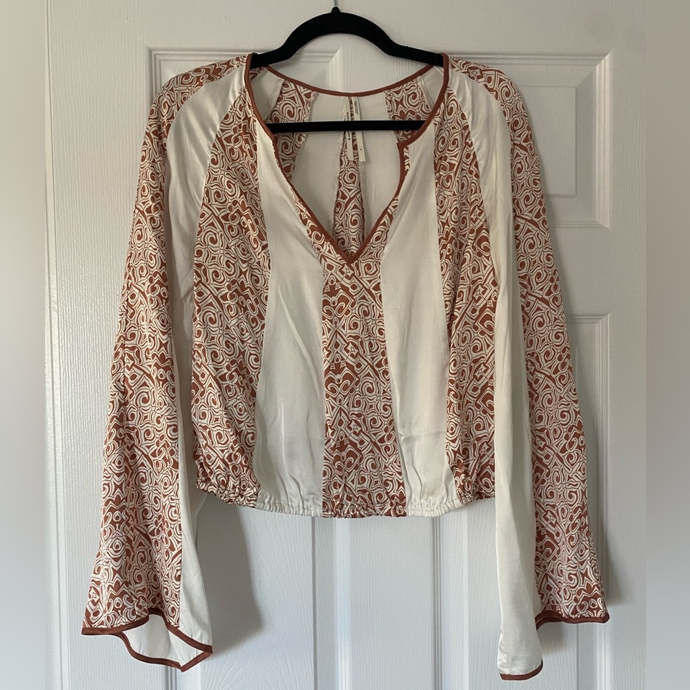 Beautiful blouse by Anthropologie. Hand wash. Material: 100% viscose.